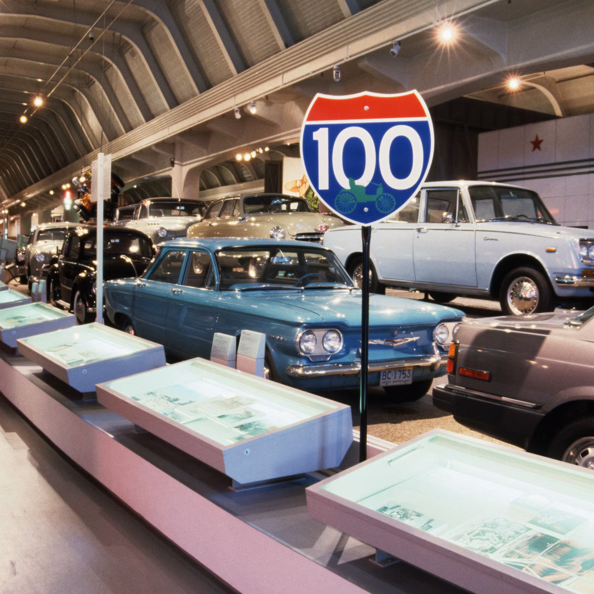 Interior view of the historic Ford Piquette Avenue Plant with vintage cars parked on original wood floors